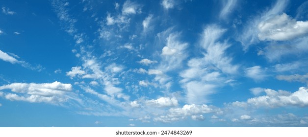 Sun shining through the puffy clouds. Sky view. Beautiful sunny sky. Background with clouds on blue sky. Clouds on blue sky.